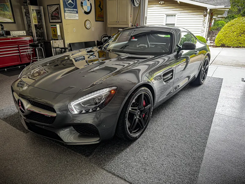 Ceramic-coated gray Mercedes-AMG GT with mirror-gloss reflections in a collector's garage