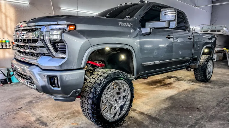 Gray lifted Chevrolet Silverado 2500 High Country after full paint correction and ceramic coating