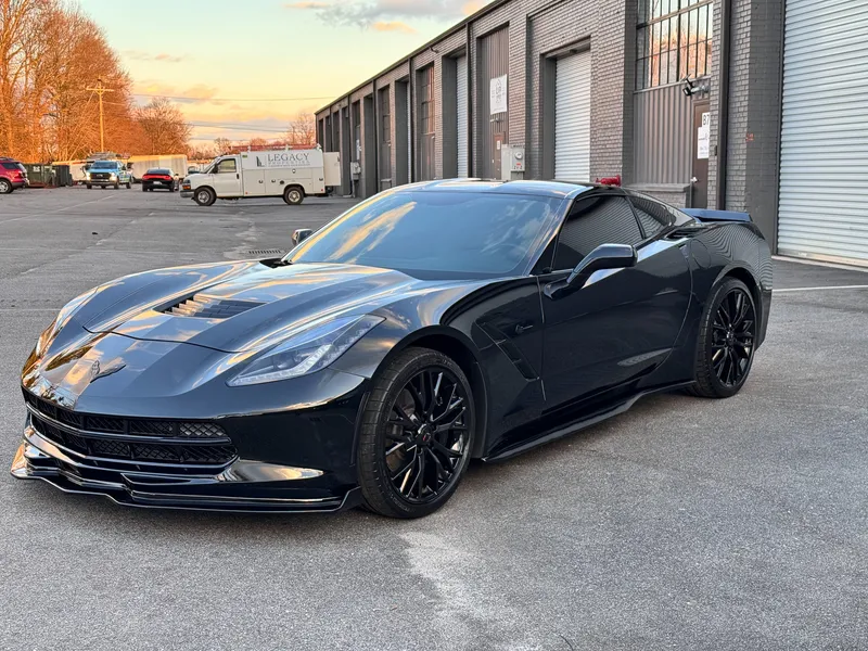 Black Corvette C7 Stingray with sunset reflections after correction and ceramic coating
