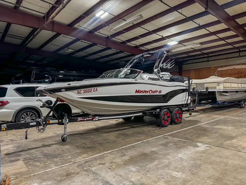 MasterCraft XT wake boat after a wash and wax, glossy black-and-white hull
