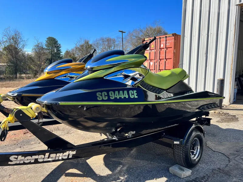 Two restored Sea-Doo RXP personal watercraft, green and gold, glossy after ceramic coating