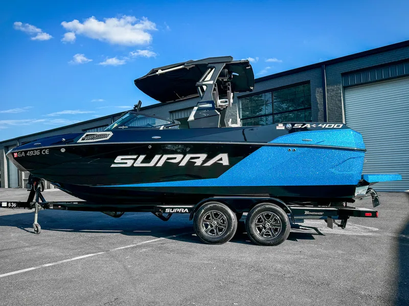 Black-and-blue-metalflake Supra SA400 wake boat after a full detail and one-step polish