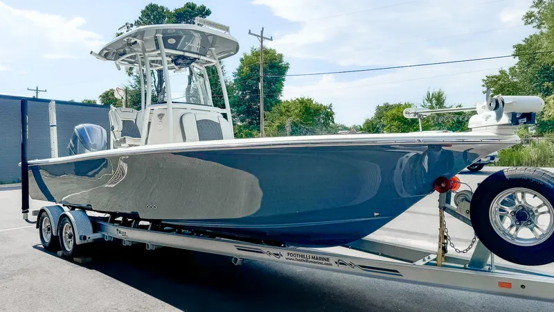 Gray Tidewater 2500 Carolina Bay center console with glossy hull after a detail and polish